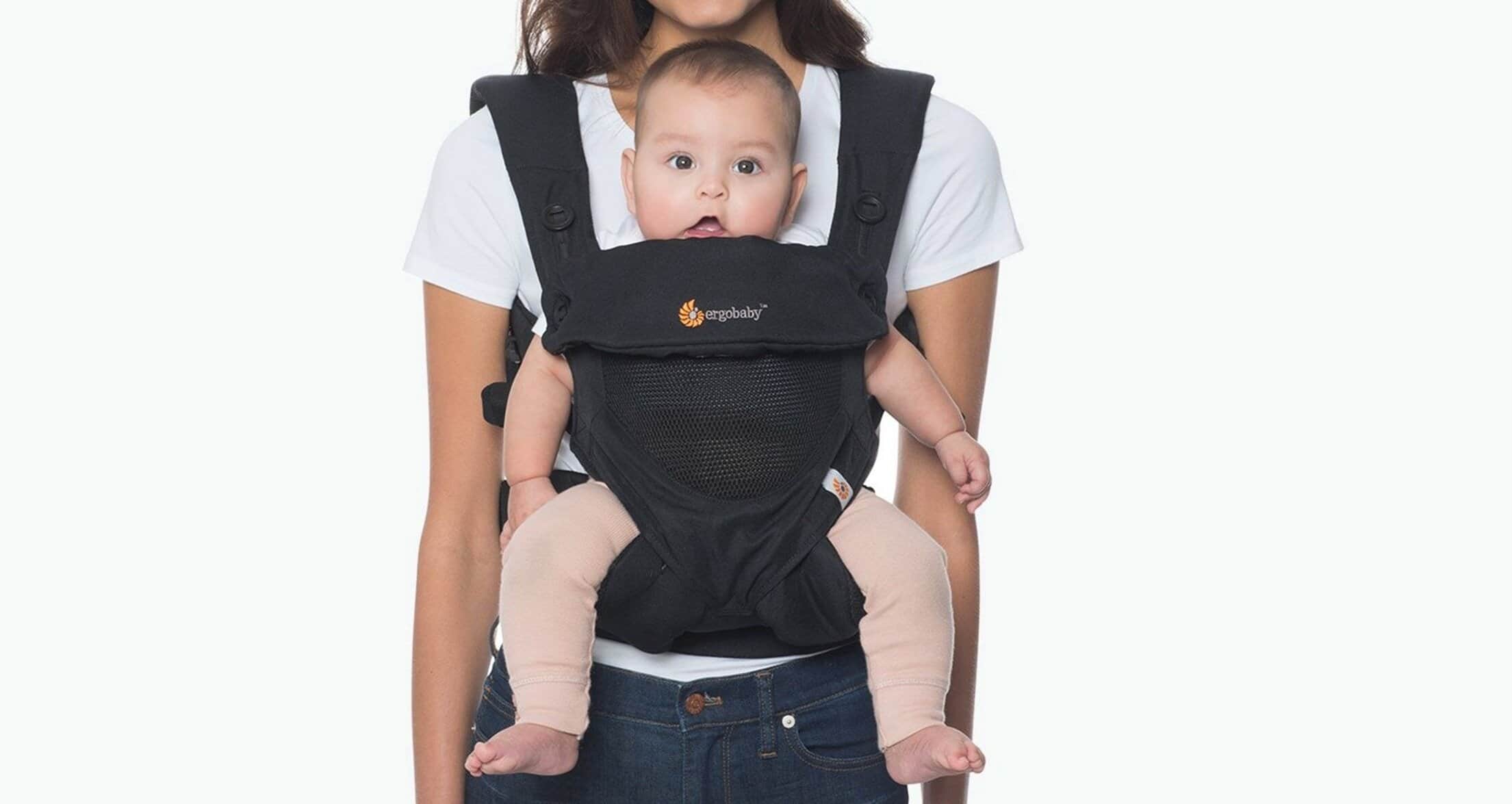 Baby carrier with a baby sitting comfortably, ideal for new mums.