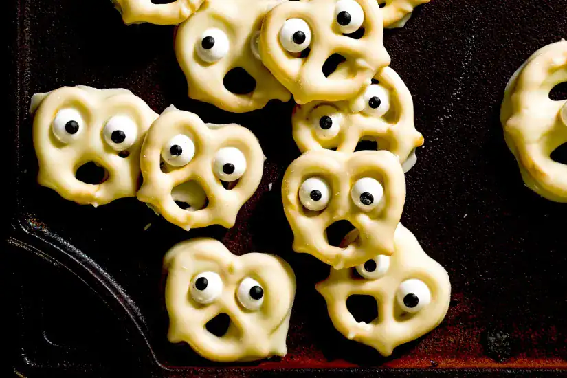 Halloween Pretzel Broomsticks with Candy Eyes.