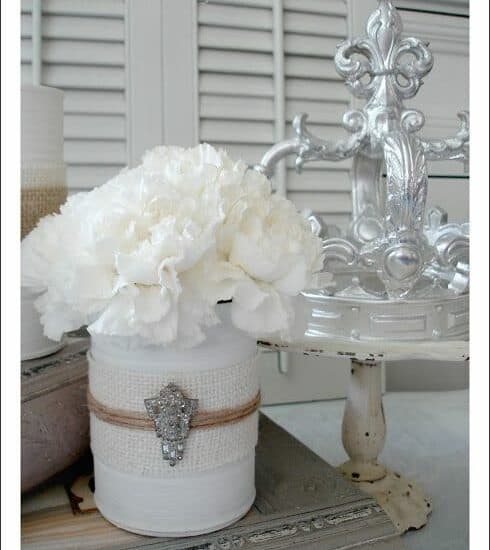 Creative upcycling of a baby formula tin into a decorative floral container.