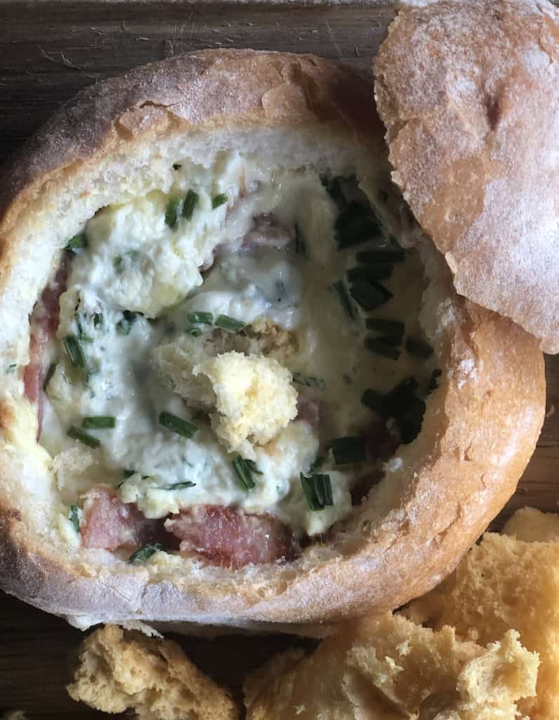 Delicious French onion dip served in a bread loaf, perfect for parties and gatherings.