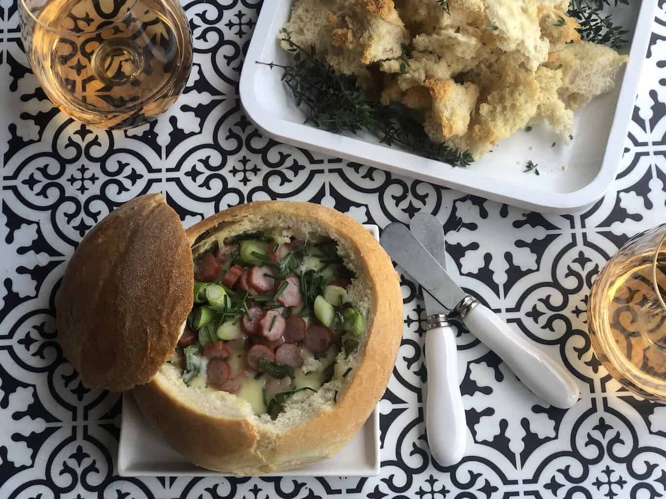 Delicious Italian-style cob loaf dip with fresh ingredients and crispy bread.