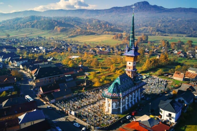 Ancient church with cemetery, set in picturesque countryside with rolling hills and mountains in the.