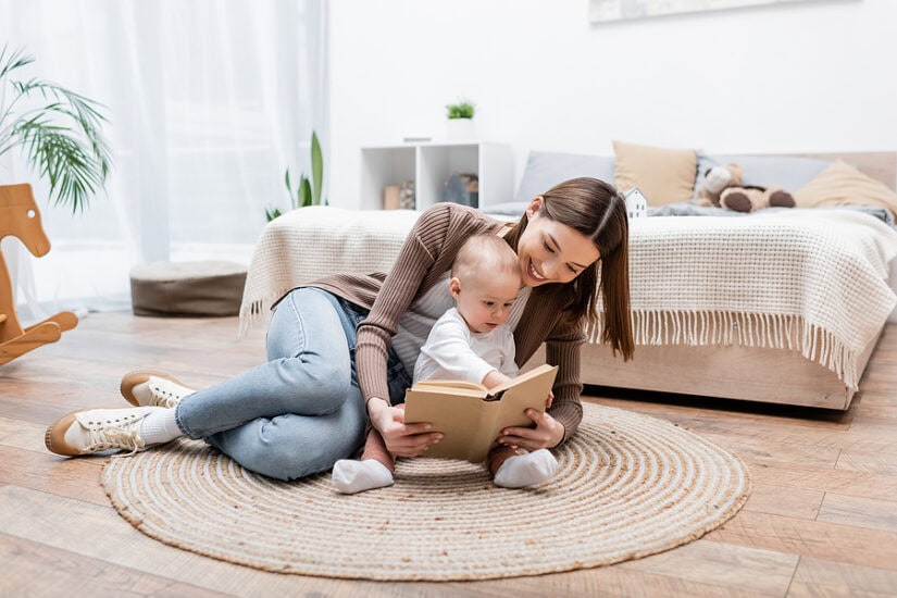 Rug shopping at home with a mother and child on a cozy rug in a bright living room.