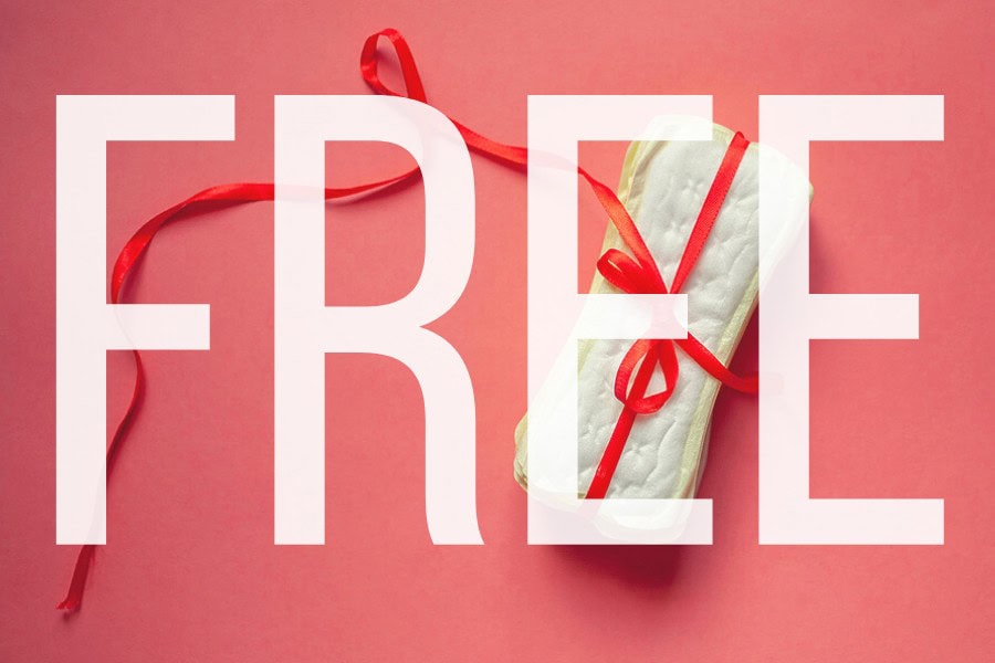 Image showing free sanitary products with a red ribbon on a pink background.