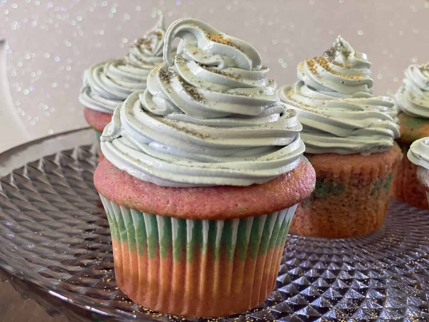 Delicious galaxy-themed cupcakes topped with swirled frosting and edible glitter, perfect for celebr.