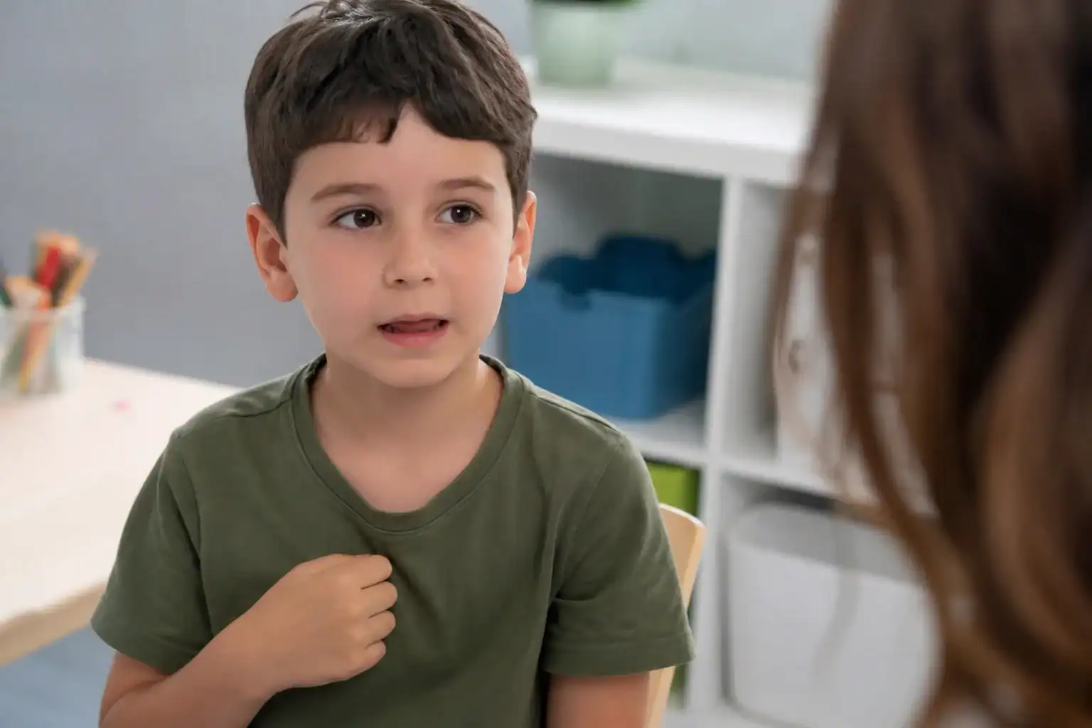 Child with speech stutter during a consultation or therapy session.
