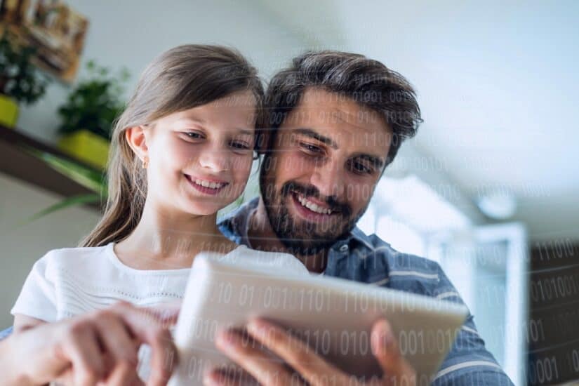 Father and daughter enjoying educational activities at home.