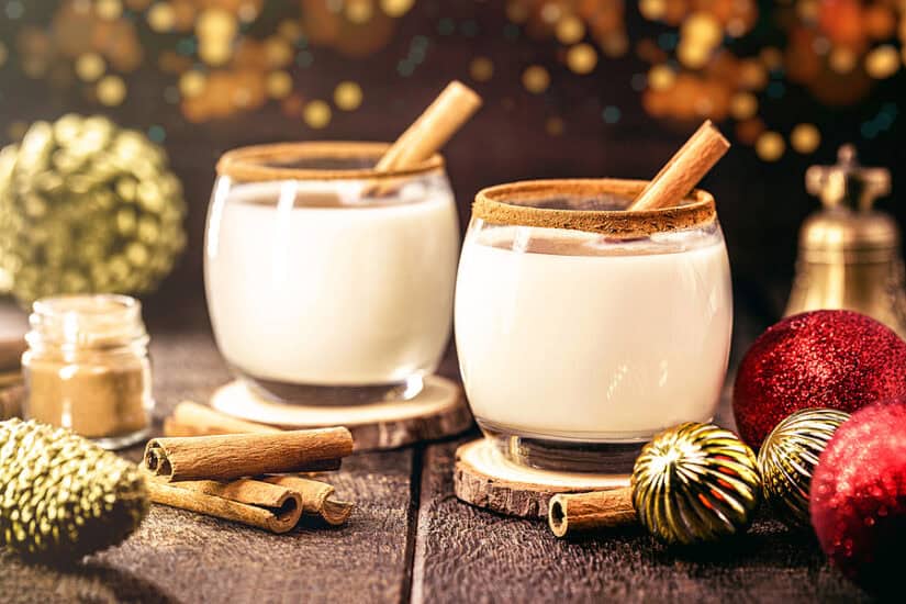 Eggnog with cinnamon sticks for Christmas dessert.