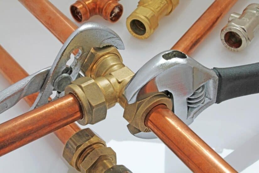 Pipe fittings and tools for hot water system repair.