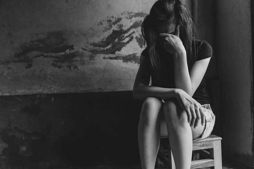 Domestic violence victim feeling distressed and alone.