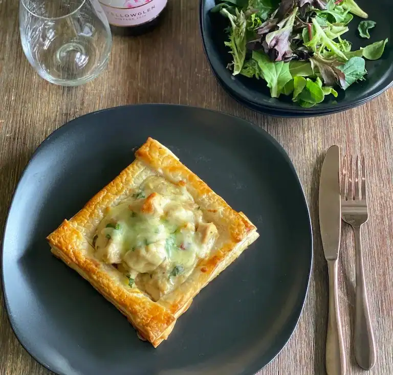 Chicken Vol Au Vent with creamy filling and melted cheese on flaky pastry.