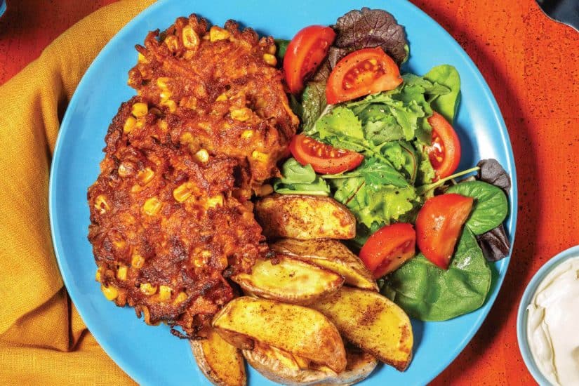 Bacon and corn fritters served with fresh salad and potato wedges. Perfect for a delicious, easy mea.