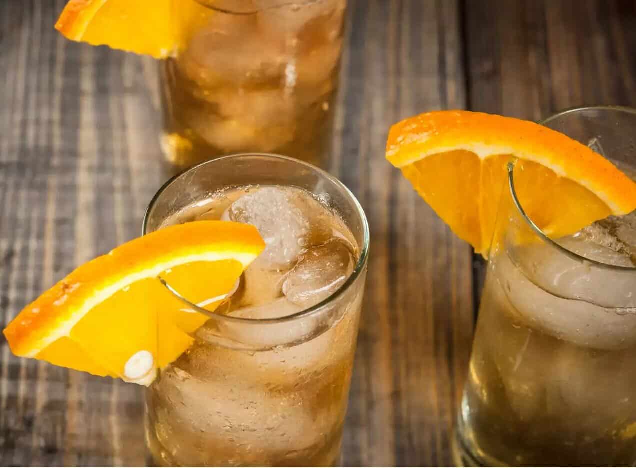Refreshing Morning Glory Cocktail with orange slices and ice.