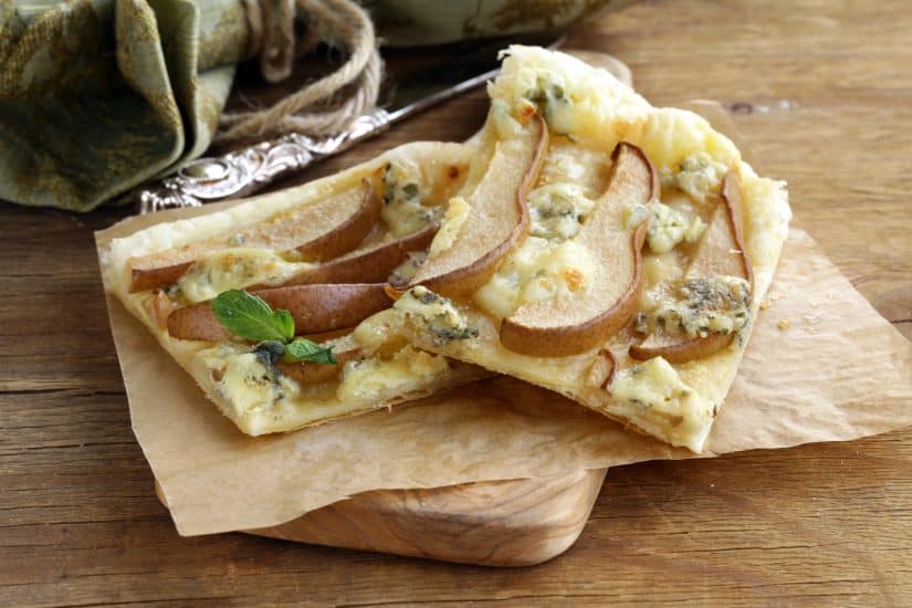 Delicious pear and blue cheese tart with a flaky crust, perfect for elegant snacks or light meals.