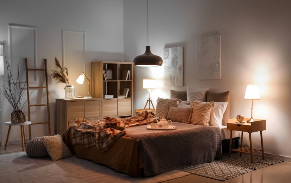 Bright and inviting bedroom featuring soft lighting, plush bedding, and stylish decor for a cozy atm.