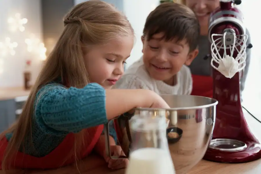 Kids baking with a stand mixer in the kitchen.
